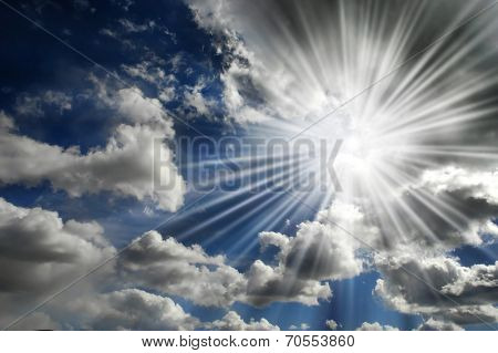 Blazing hot sun shining in blue sky with clouds