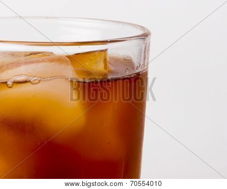 glass with ice tea full with ice cubes