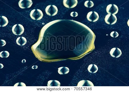 Yellow Drops On Metal. Background