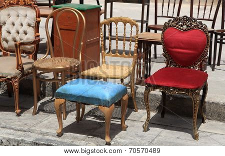 Collection Of Old Broken Chairs On The Flea Market.