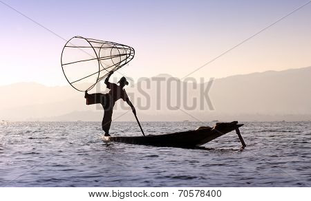 Traveling to Myanmar, outdoor photography of fisherman on traditional boat. Intha people from Shan state of Burma 