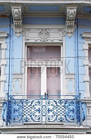Ornate Baroque Window With A Balcony In Old Blue Building