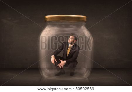 Businessman shut into a glass jar concept on background