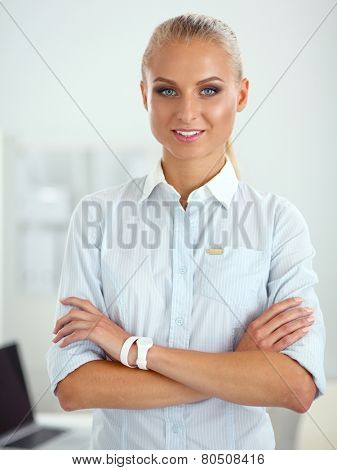 Attractive businesswoman with her arms crossed stnding