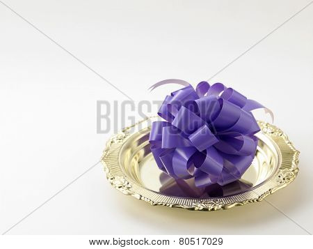 opening ceremony concept- purple ribbon bow on the golden plate