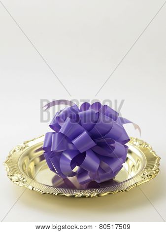 opening ceremony concept- purple ribbon bow on the golden plate