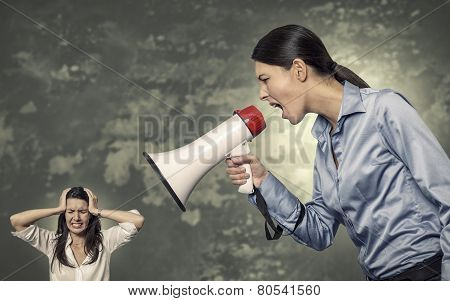 Woman Shouting Using Megaphone To Stressed Woman