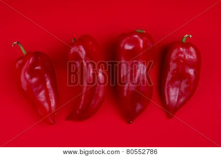 Red Peppers On Red Background