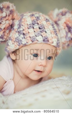 Happy little girl in cap bear