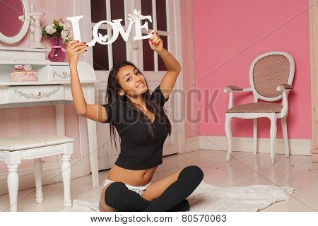 A sexy  woman in lingerie in a pink room with the words 