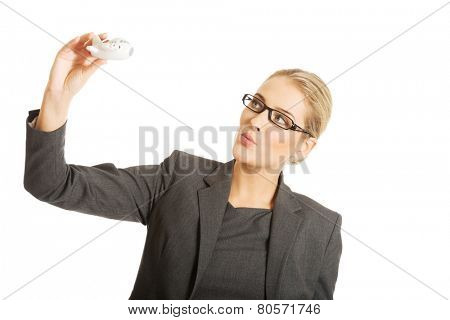 Beautiful businesswoman with plane toy in hand