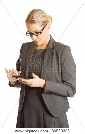 Beautiful businesswoman sending a message