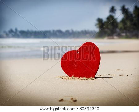 Red heart on exotic sandy beach - Love concept