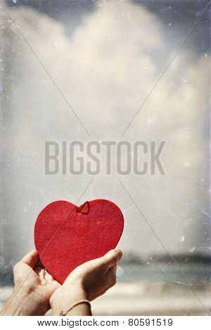 Woman hands holding red heart - Love concept vintage photo