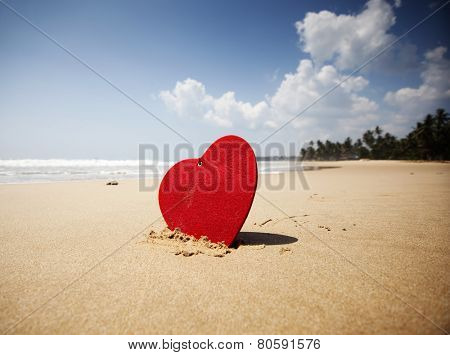 Red heart on exotic sandy beach - Valentine's day concept