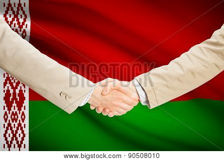 Businessmen Handshake With Flag On Background - Belarus