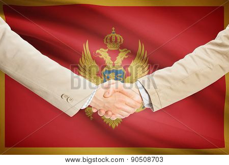 Businessmen Handshake With Flag On Background - Montenegro