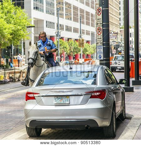 Policeman On Horse Checks Correct Parking