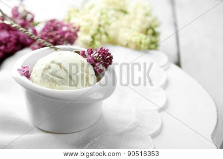 Beautiful composition with tasty ice cream and lilac flowers