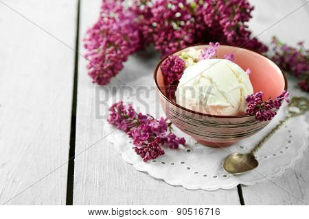 Beautiful composition with tasty ice cream and lilac flowers