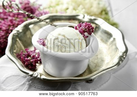 Beautiful composition with tasty ice cream and lilac flowers