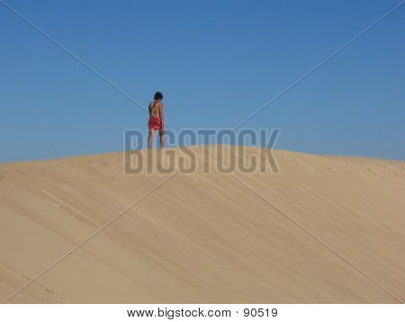 Woman Walking In The Dunes