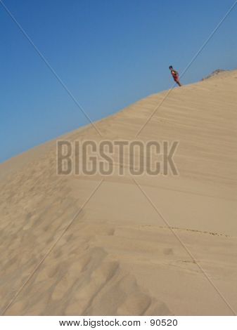 Woman Walking In The Dunes