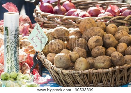 Fresh Organic Yukon Gold Potatoes And Onions At Farmer's Market