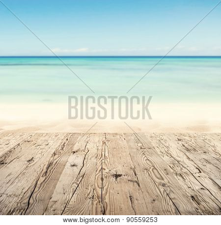 Empty wooden pier with view on sandy beach. Free space for text or product placement