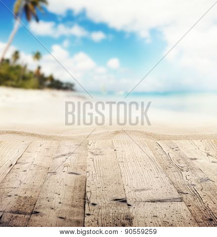 Empty wooden pier with view on sandy beach. Free space for text or product placement