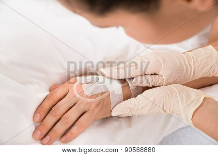 Close-up Of A Iv Drip In Patient's Hand