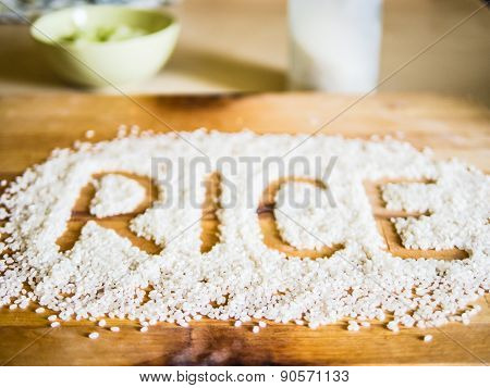 Rice word made of rice on wooden board