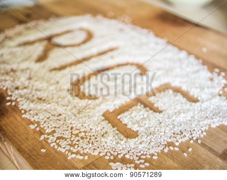 Rice word made of rice on wooden board