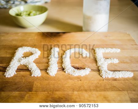 Rice word made of rice on wooden board
