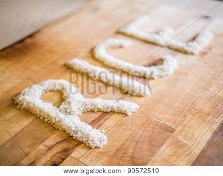 Rice word made of rice on wooden board