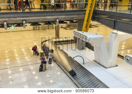 Passenger At The Beggage Belt At Terminal 4 At Barajay Airport