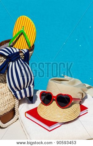 utensils for a nice relaxing vacation day lying next to a swimming pool. relaxation on vacation.