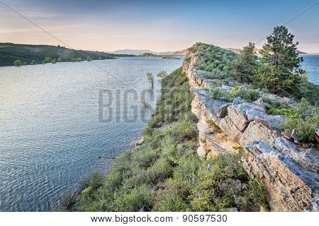 sandstone cliff and lake at dusk - Horsetooth Reservoir near Fort Collins, Colorado, at springtime