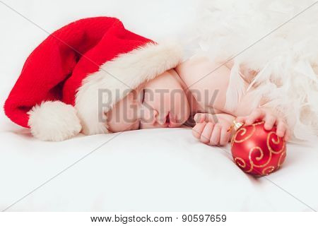 Small boy sleeping in a New Year's cap