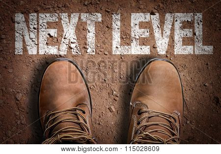 Top View of Boot on the trail with the text: Next Level