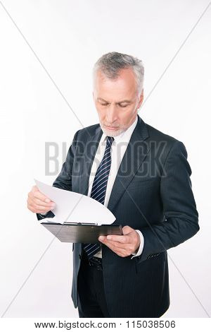 A Portrait Of Aged Focused Man Working With Clipboard