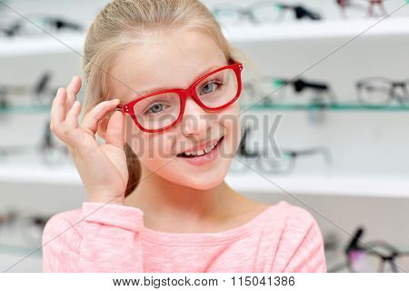 little girl in glasses at optics store