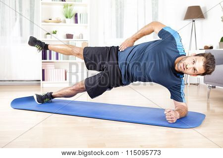 Athletic Man In Side Planking With One Leg Raised