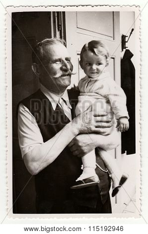 Vintage photo of a small girl with her grandfather circa 1941