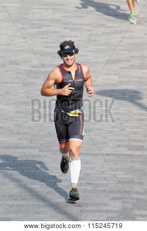 Man Running In Bright Sunlight On Cobblestone