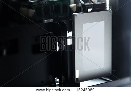 SSD or Solid State Drive used in most recent computers. Silver SSD drive with blank label in a PC case or chassis. Shallow depth of field.