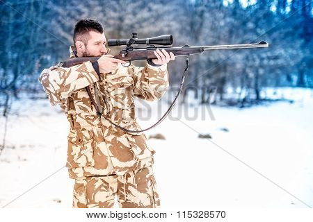 Military Man Holding A Sniper Rifle And Aiming At Enemy On The Battlefield