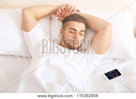 Young man snoozing on bed