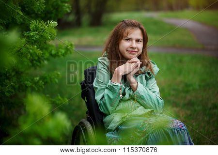 Portrait Of A Yong Beautiful Woman Smiling In A Wheelchair In Th