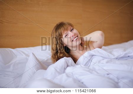 Girl smiling while lying in bed